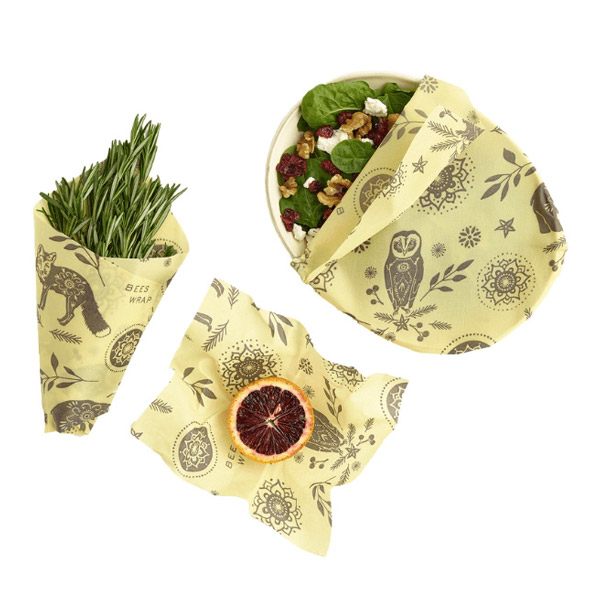 Isolated image of Bee's Wrap beeswax wraps covering various food items.